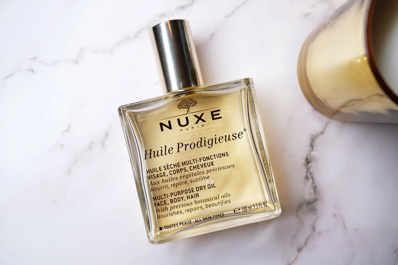 NUXE<br> <b> HUILE PRODIGIEUSE aux 7 huiles végétales présieuses</b><br><h5>100ml</h5>Origine France </h6> <img style="vertical-align: middle;" src=" https://shorturl.at/bDMR9">